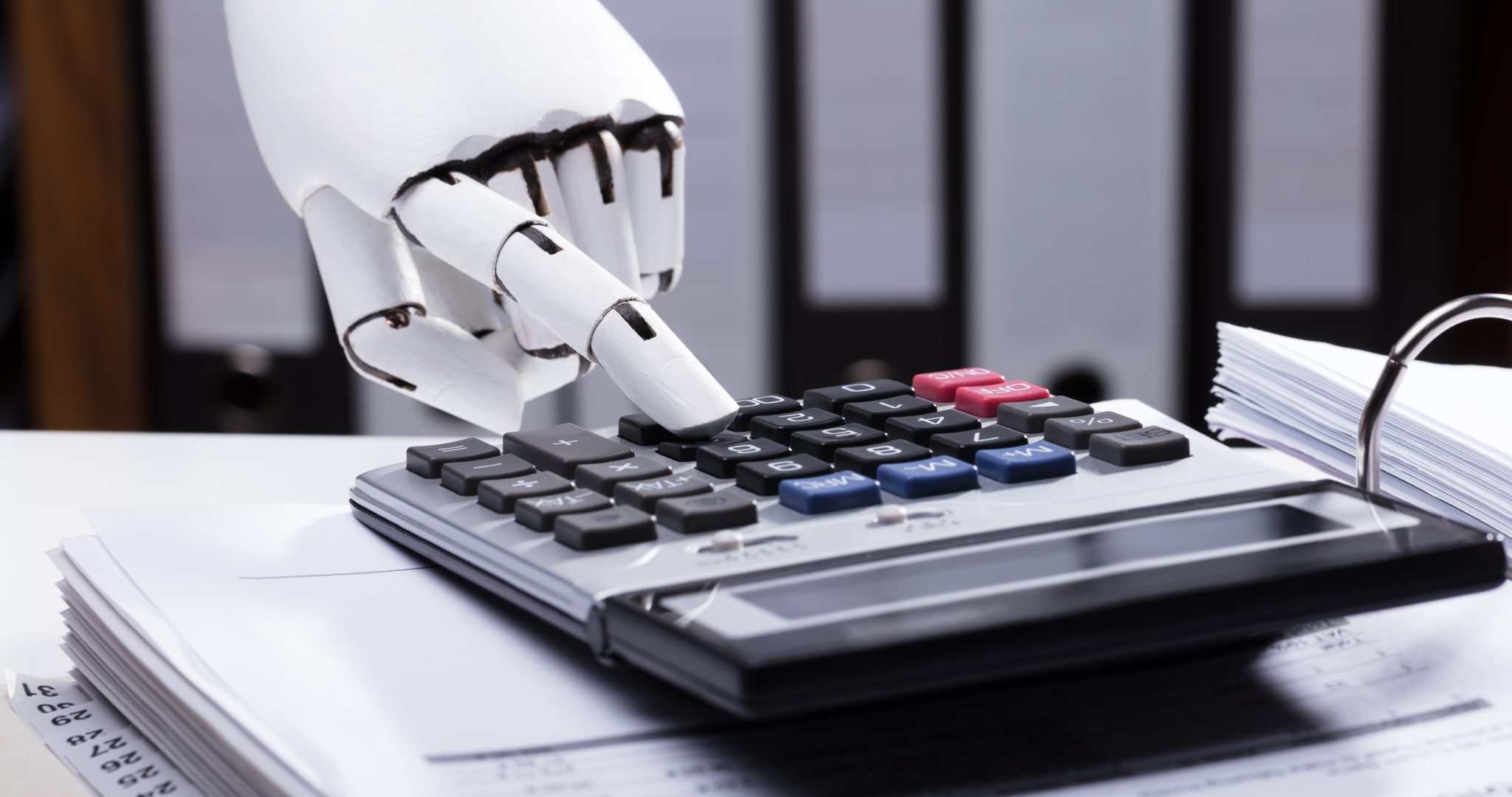 Close-up,Of,A,Robotic,Hand,Using,Calculator